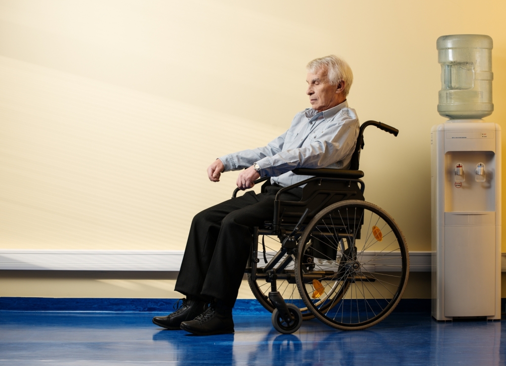 Thoughtful senior man in wheelchair in nursing home